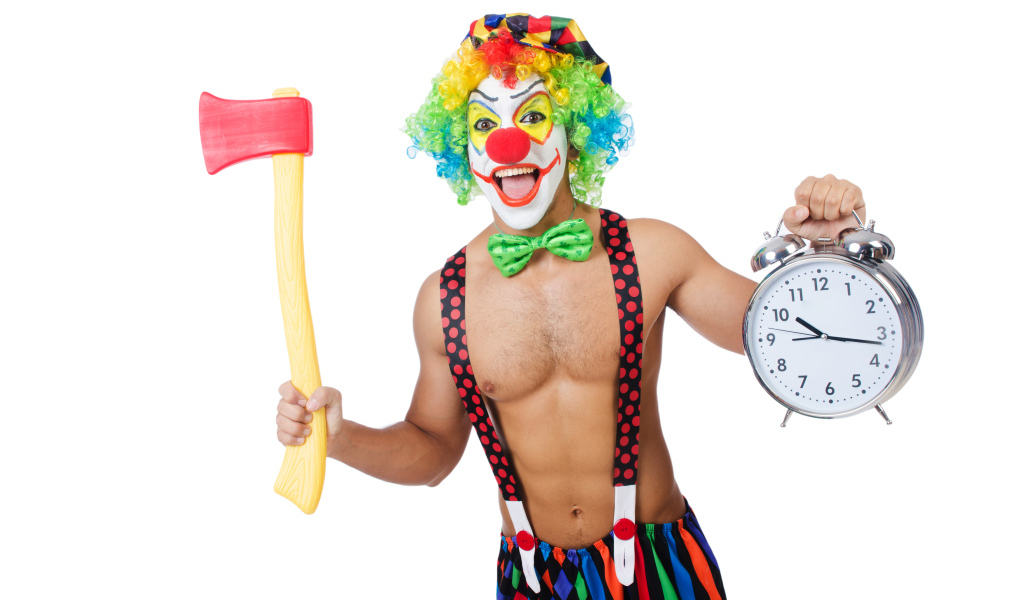 Man in a clown suit with an ax and a clock in his hand on a white background