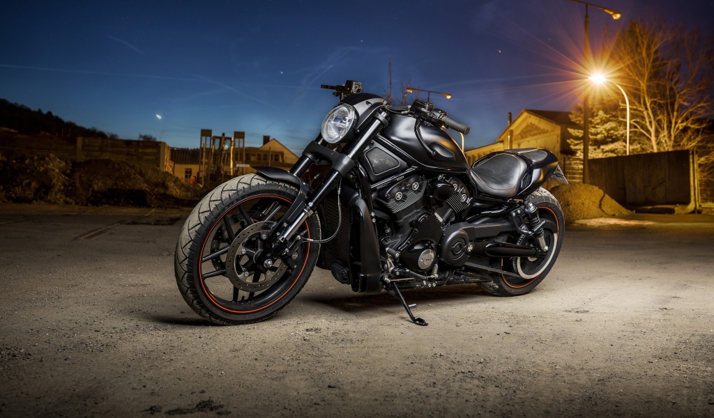 Мощный черный мотоцикл Harley Davidson стоит на улице с фонарем