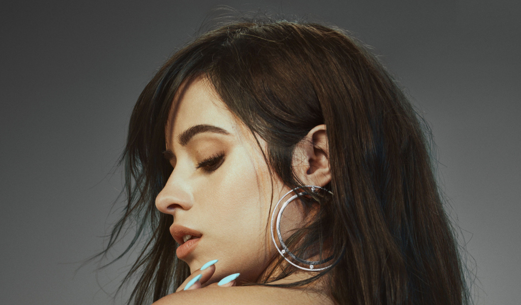 Певица Камила Кабельо на сером фоне крупным планом 