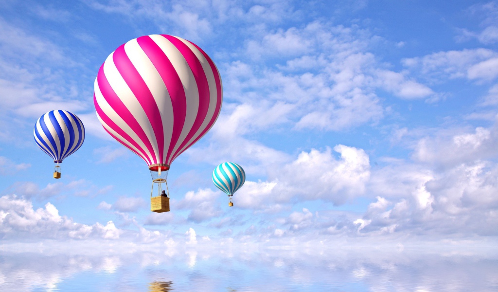 Яркие воздушные шары в небе над водой