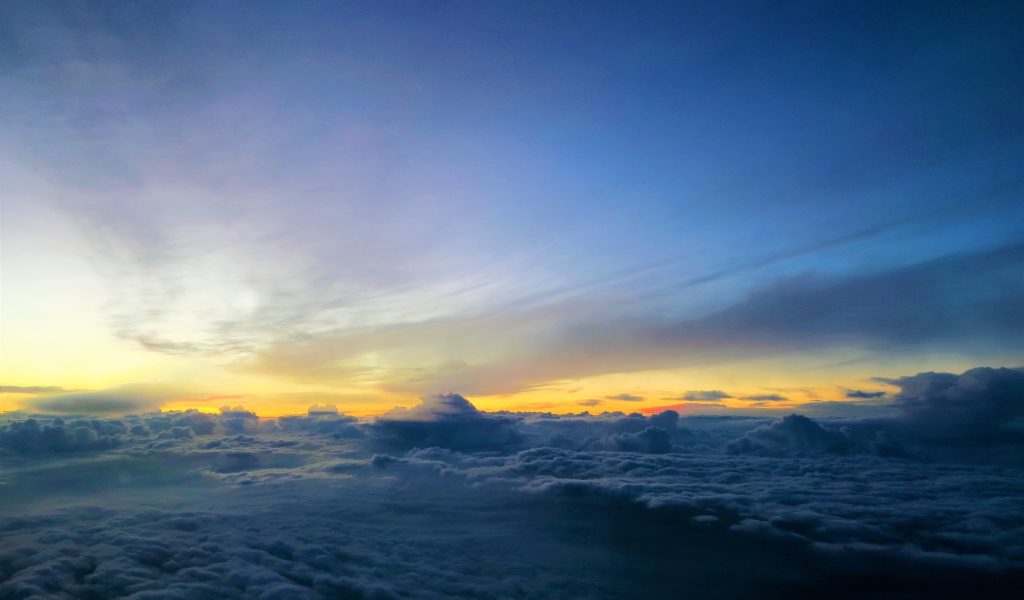 Белые низкие облака под голубым небом на рассвете