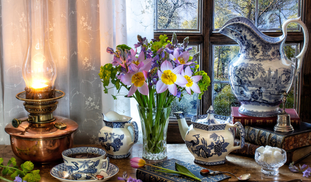 Букет цветов в вазе на столе с красивым сервизом