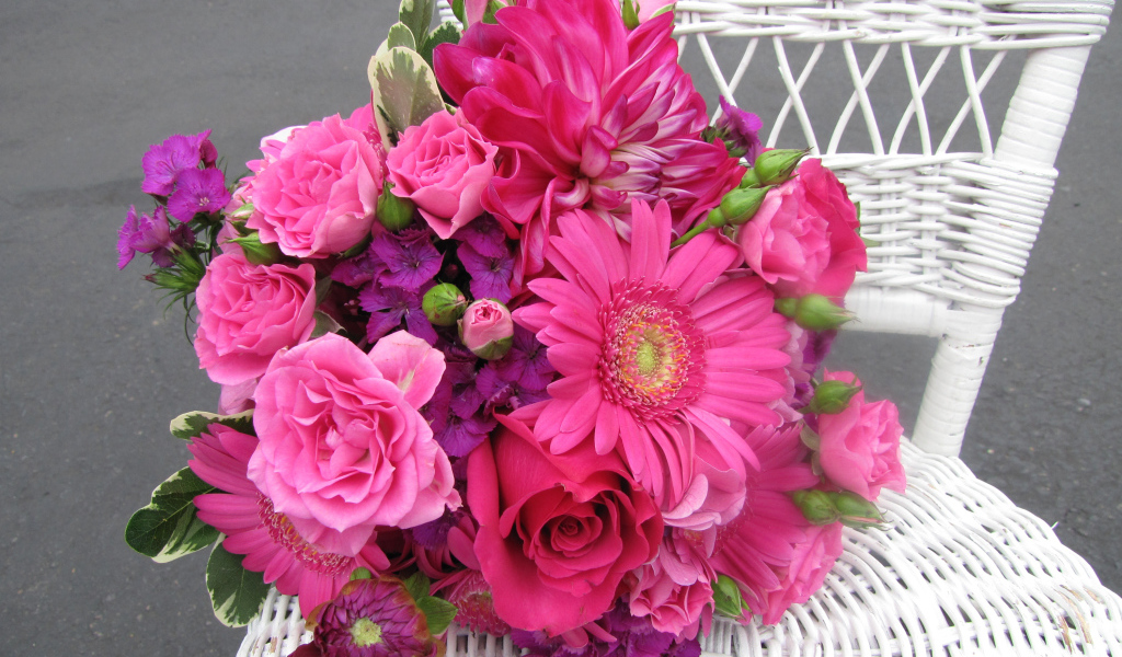 Букет с розовыми цветами георгины, розы, герберы и флоксы на белом стуле