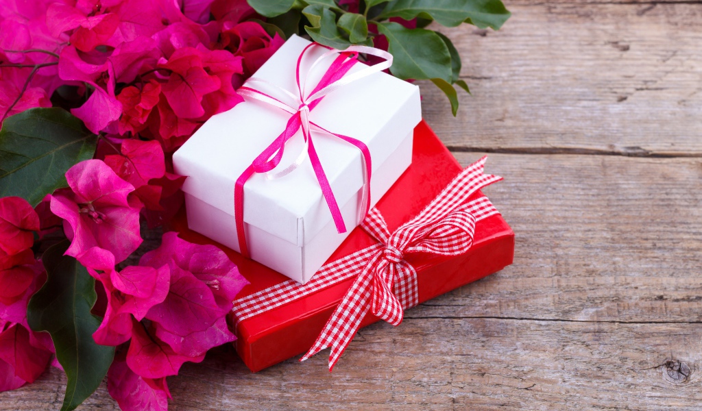 Две коробки с подарками на столе с цветами
