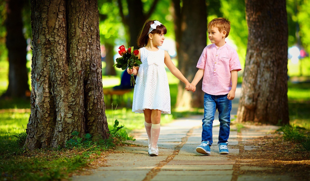 Boy and girl walk in the park