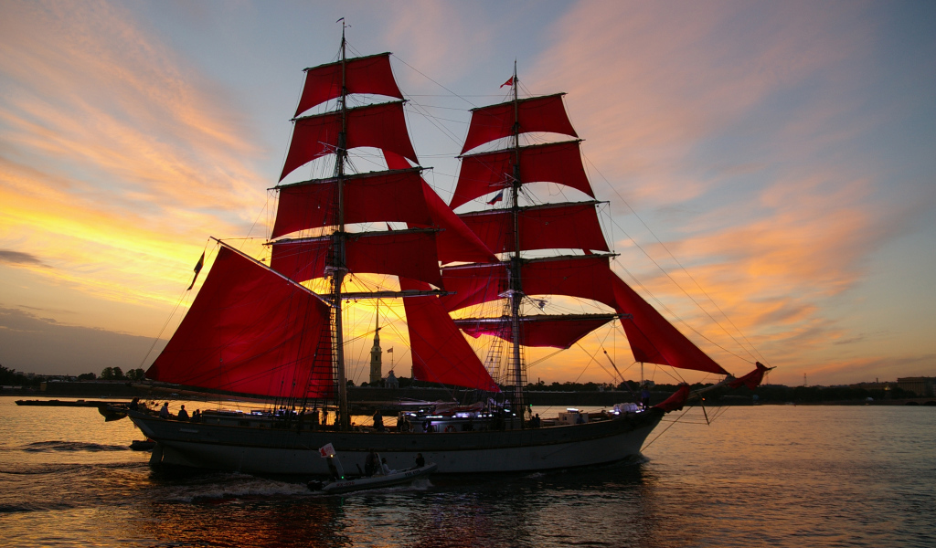 Большой корабль с алыми парусами на фоне заката