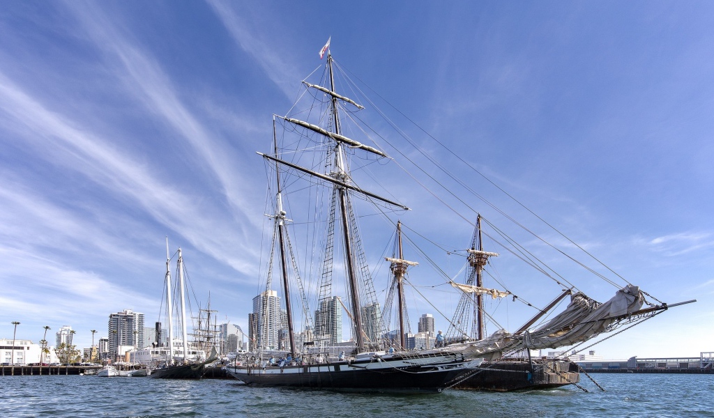Large sailing boat on a background of blue sky in the port near the city
