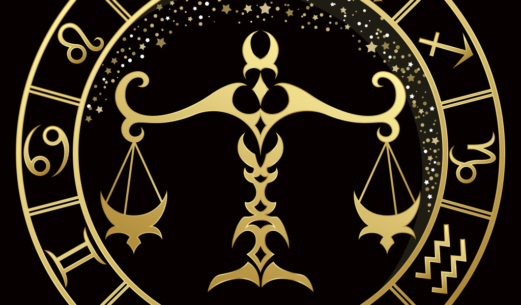 Золотой знак зодиака весы на черном фоне