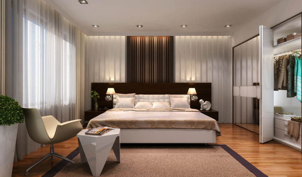 Большая кровать в просторной спальне со шкафом 