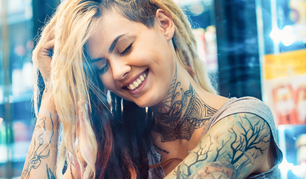 Smiling girl with tattoos on her body
