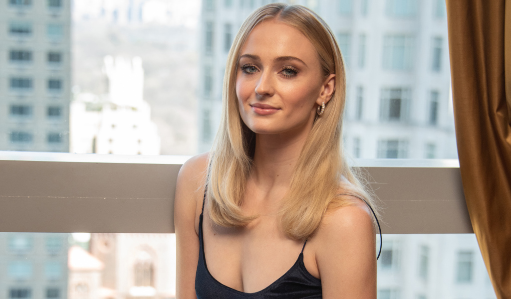 Стильная красивая блондинка, актриса Софи Тёрнер у окна