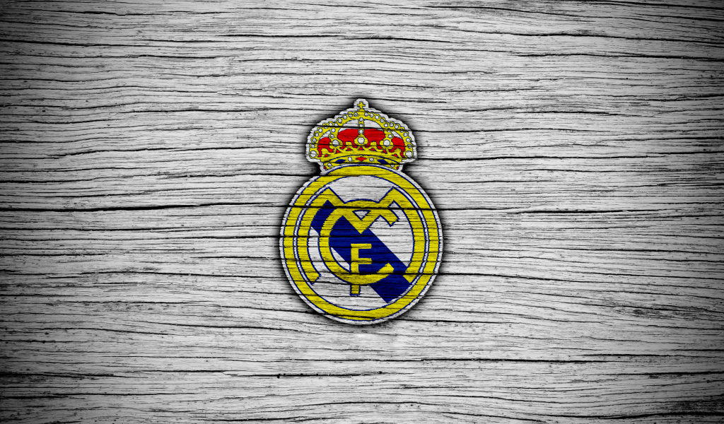 Логотип футбольного клуба Реал Мадрид на сером фоне