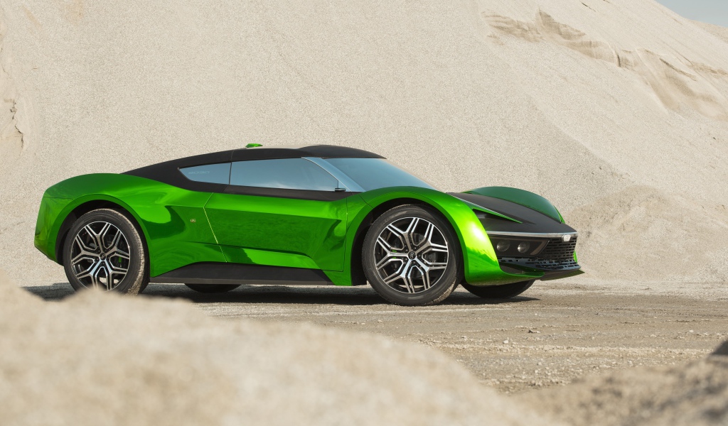 Зеленый автомобиль GFG Vision 2020 года стоит на песке