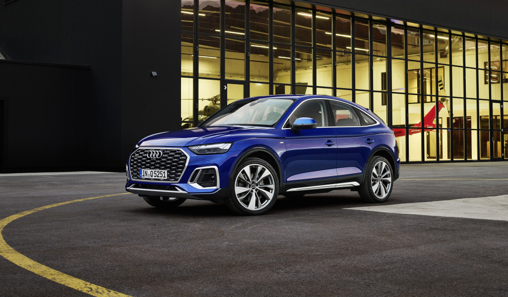 Автомобиль Audi TTS, 2021 года у здания с большими окнами