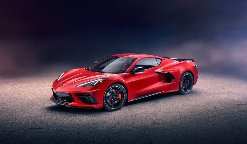 Красный автомобиль Chevrolet Corvette Stingray Z51 Preserial  на сером фоне