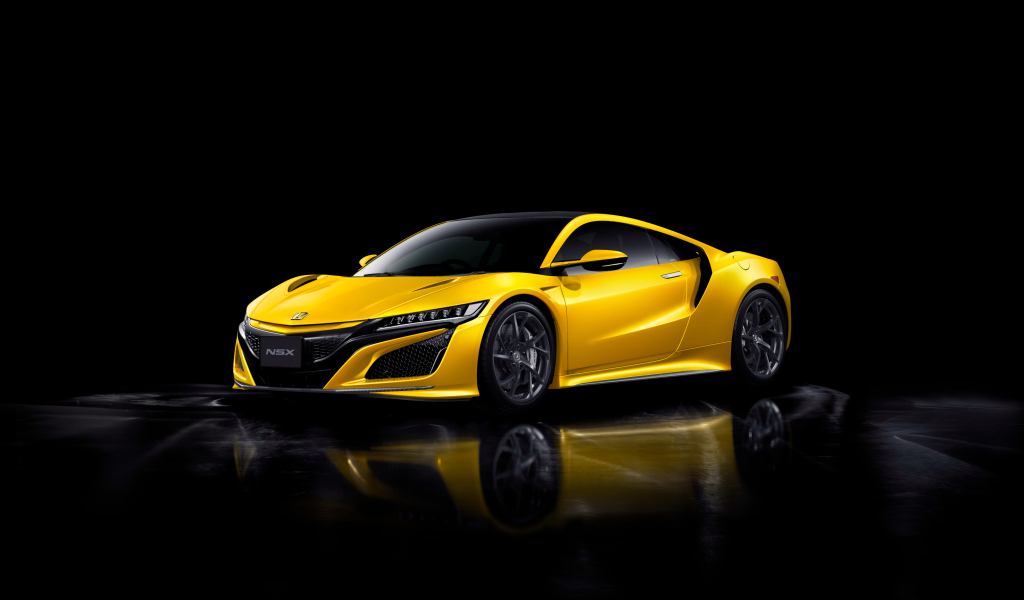 Желтый автомобиль Honda NSX на черном фоне