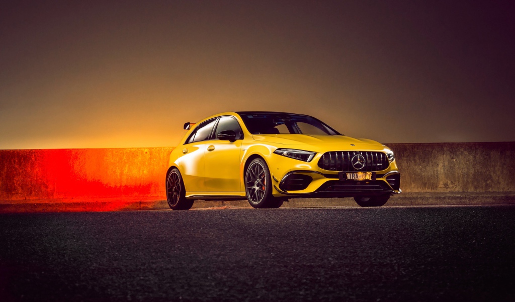 Желтый автомобиль Mercedes-AMG A 45 S,  2020 года на асфальте 