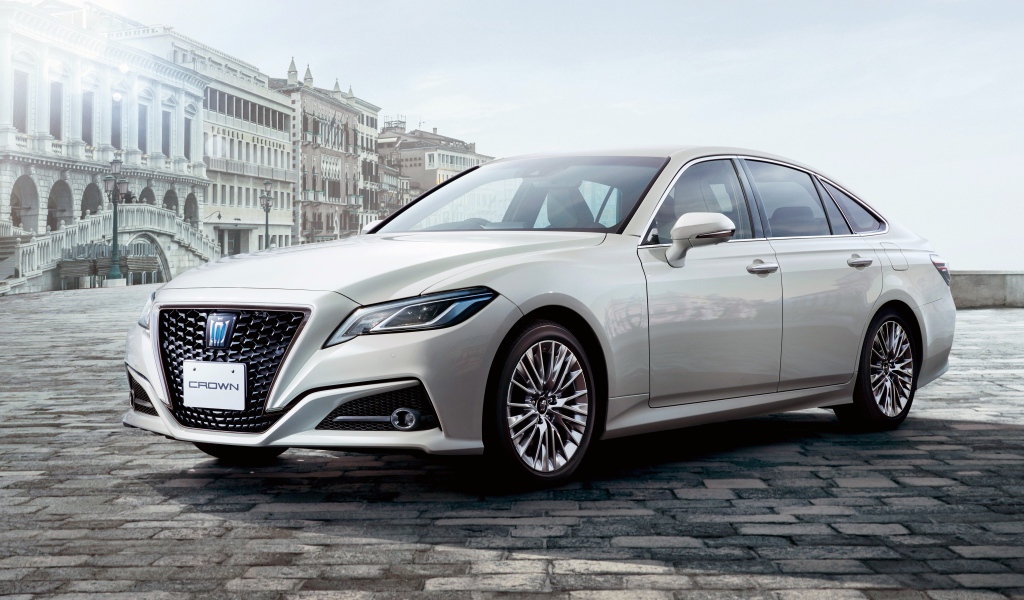 Стильный автомобиль Toyota Crown S, 2020 года на фоне здания