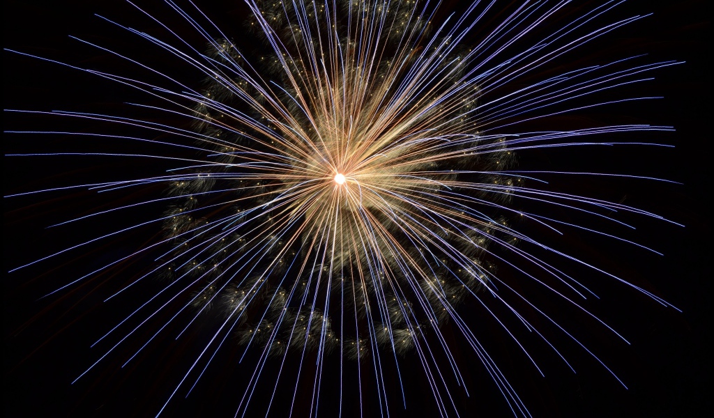 Bright sparks of fireworks in the night sky