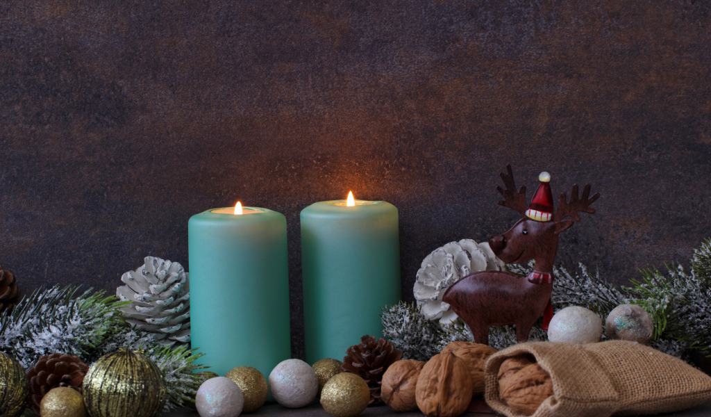 Зажженные свечи на фоне стены с декором