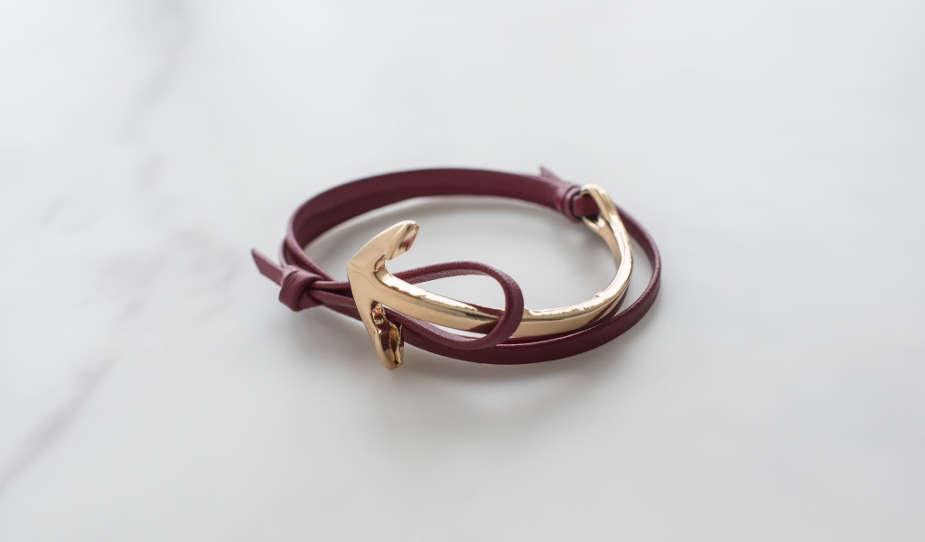 Кожаный браслет на руку на сером фоне