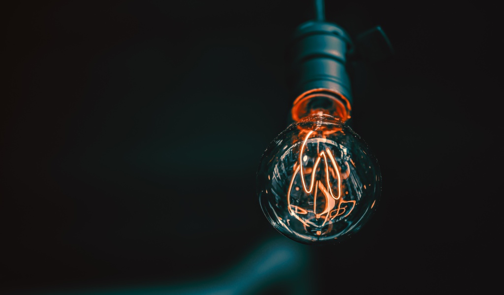 Зажженная лампа накаливания под потолком