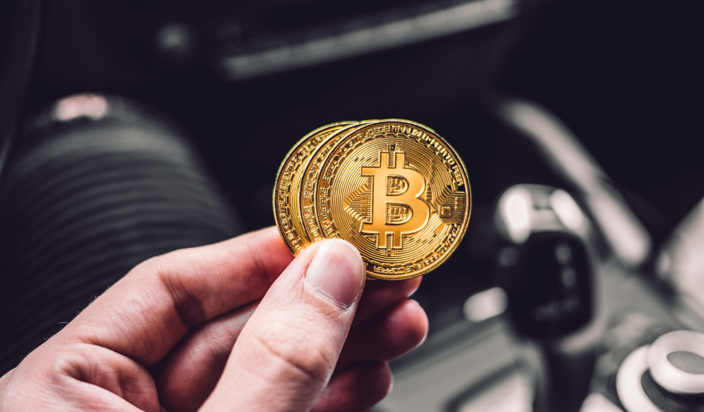 Две монеты биткоин в руке 