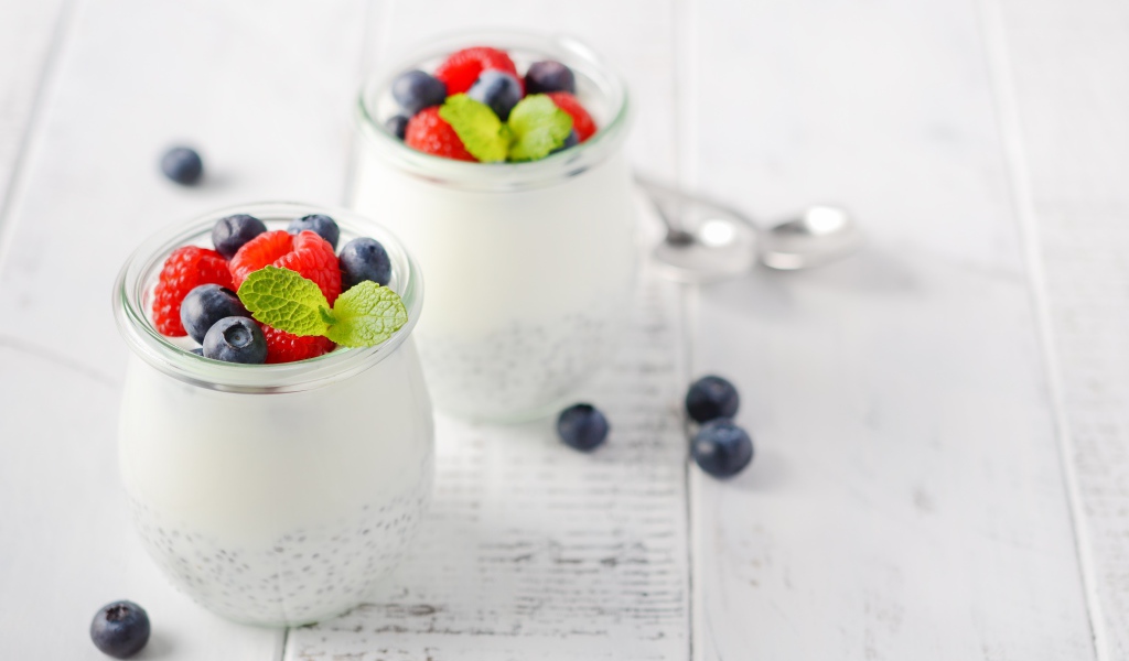 Yogurt in a jar with goji seeds and blueberries and raspberries