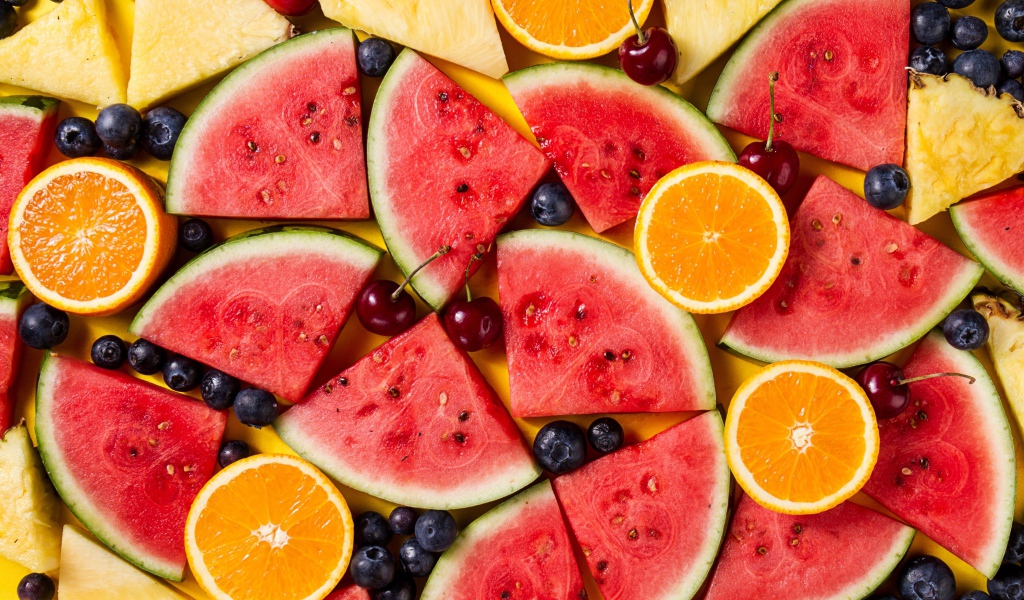 Вкусные свежие фрукты на желтом столе 