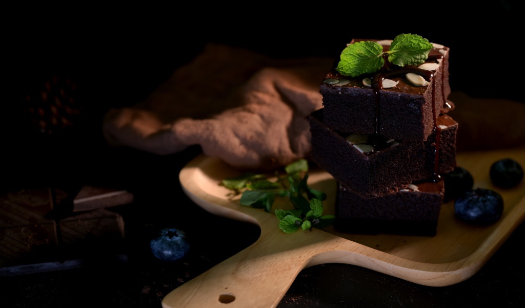 Шоколадный десерт брауни на доске с ягодам черники 