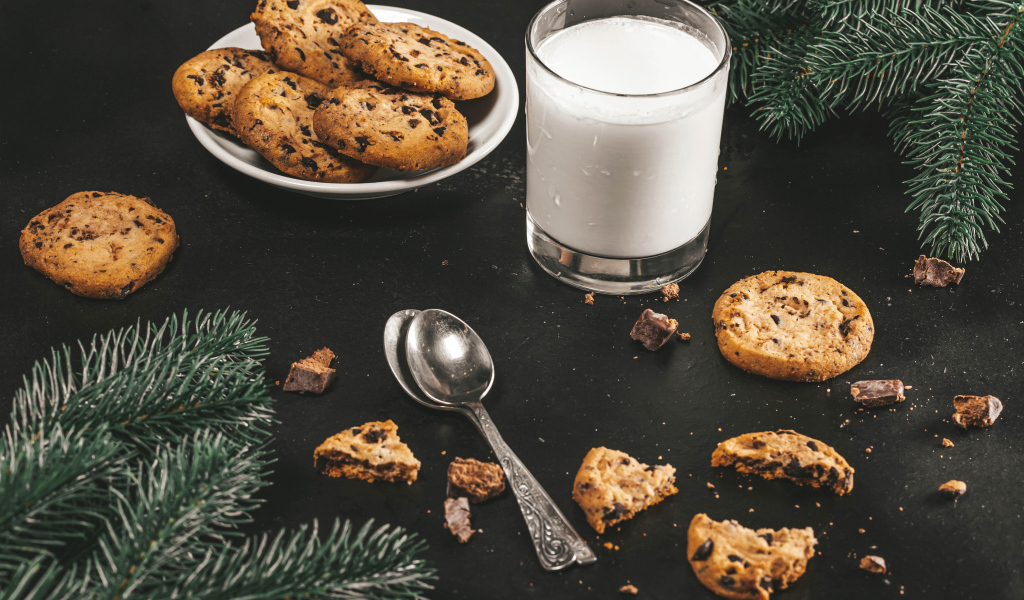 Cookies on a table with milk and spruce branches