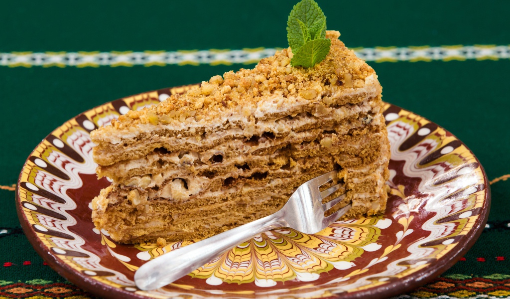 Delicious honey cake with nuts on a beautiful plate
