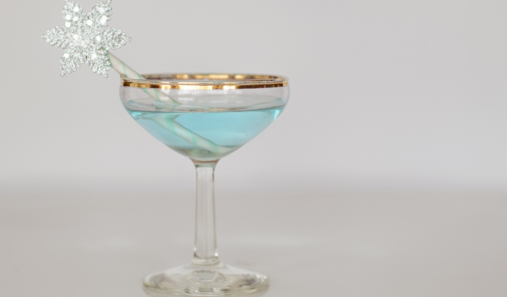 Голубой коктейль в бокале с трубочкой