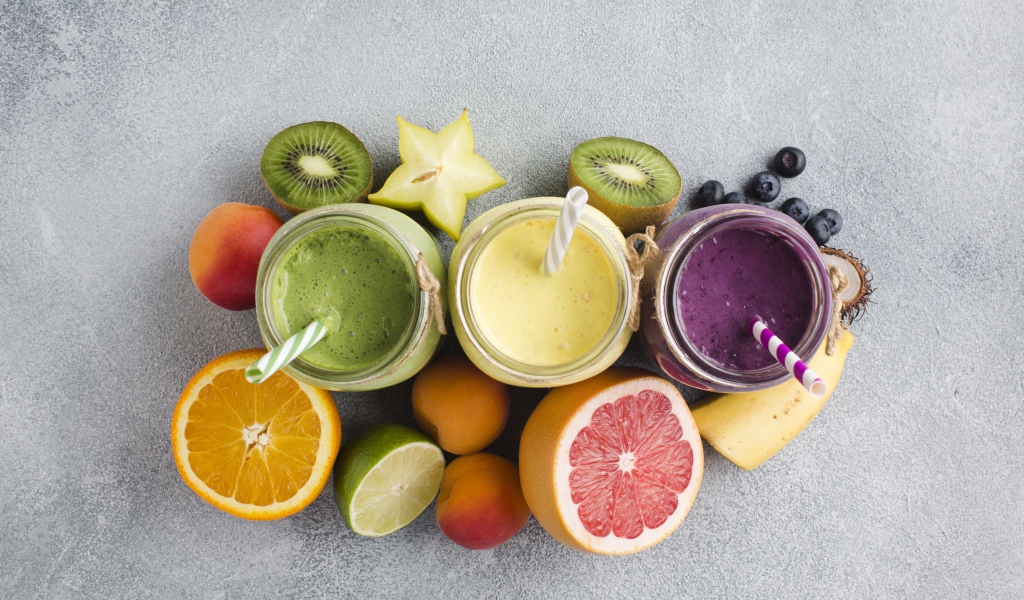 Смузи в банках на столе в ягодами и фруктами