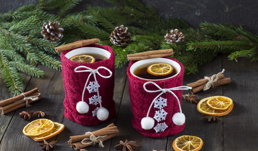 Две чашки горячего чая с лимоном на столе с еловыми ветками