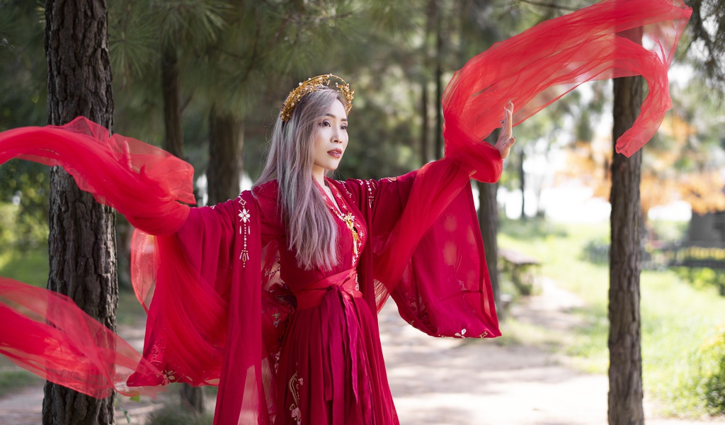 Красивая девушка азиатка в красном национальном костюме 