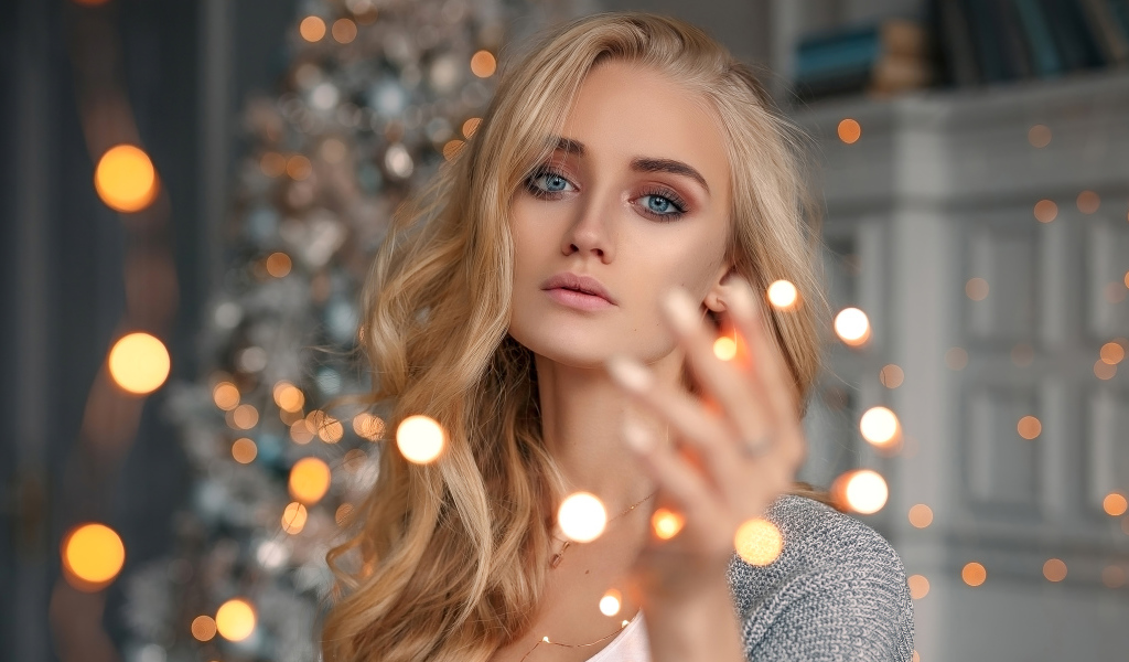 Красивая голубоглазая блондинка с гирляндой в руке