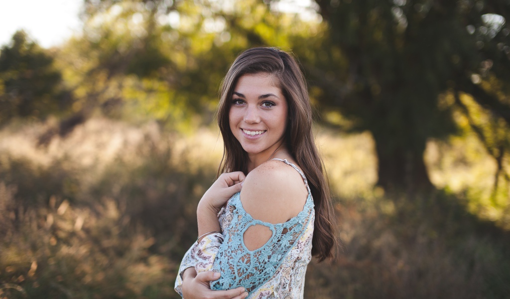 Милая улыбающаяся девушка в лесу 