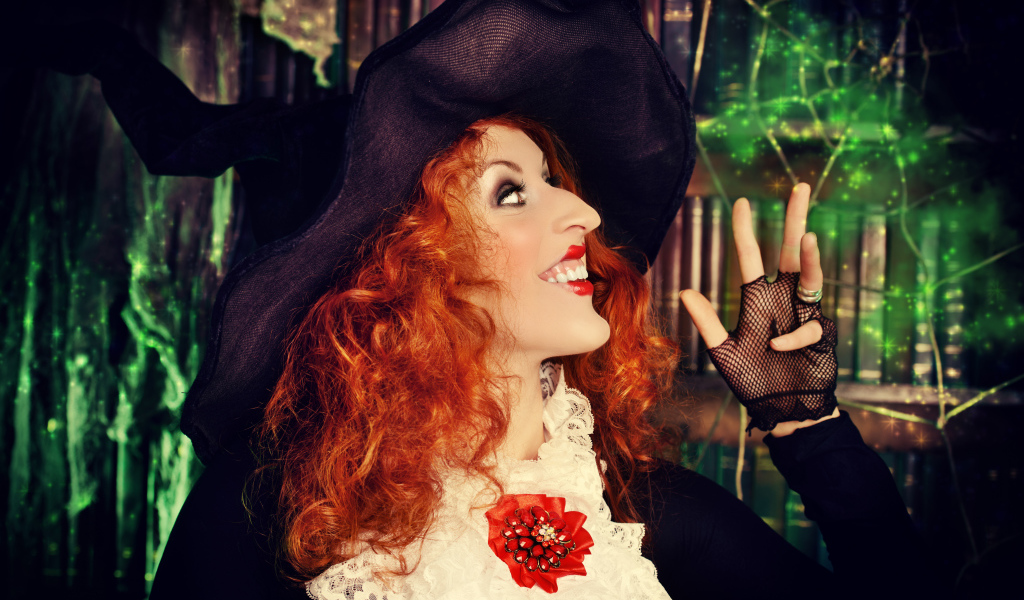 Halloween red-haired girl in a witch costume