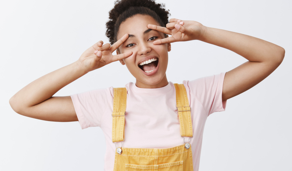 Счастливая девушка с руками у лица 