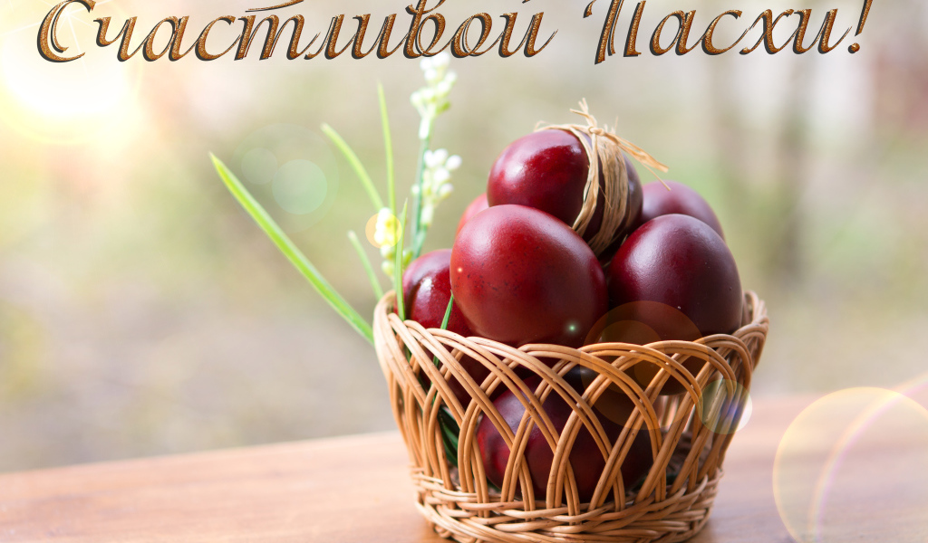 Красные крашеные яйца в корзине, открытка с надписью Счастливой Пасхи