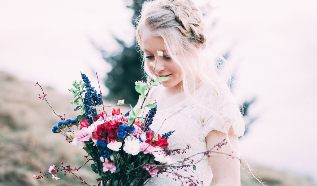 Beautiful girl bride with a wedding bouquet in her hands