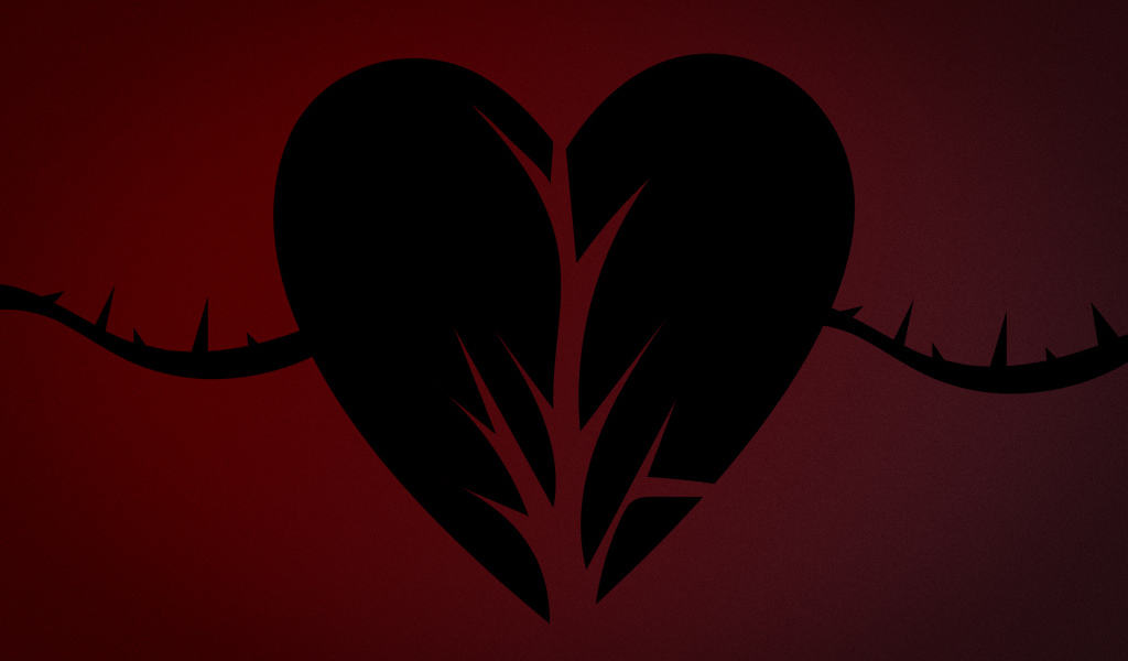 Черное разорванное сердце на красном фоне