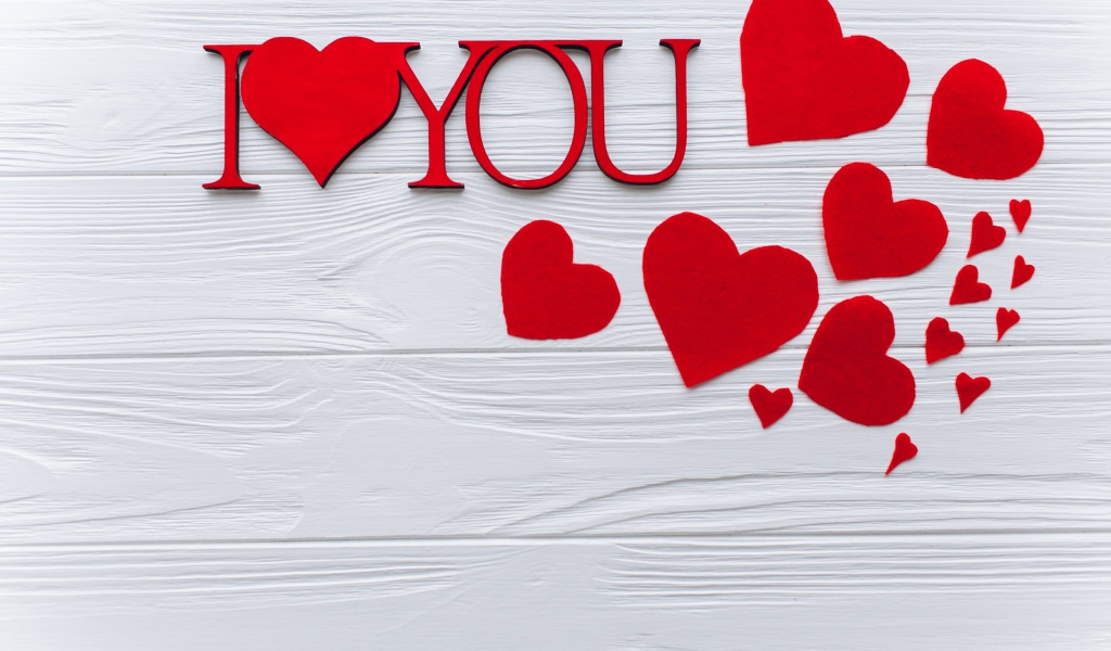 Надпись Я тебя люблю с красными сердечками на столе