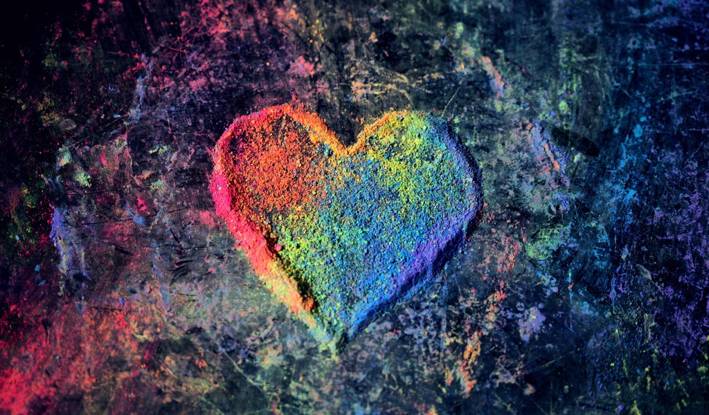 Multi-colored heart from dry paint on a gray background