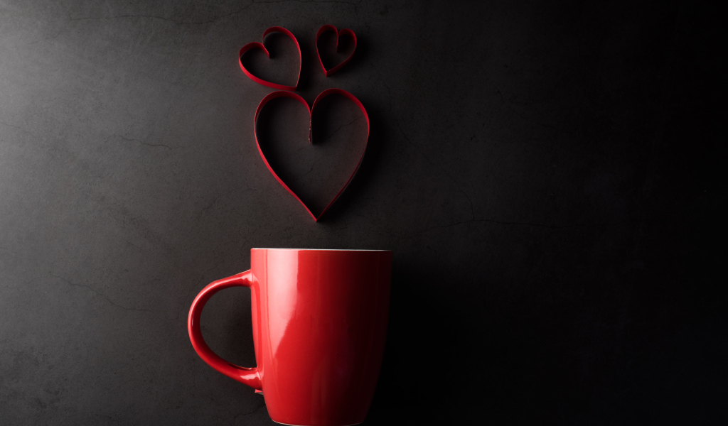 Красная чашка на сером фоне с сердечками