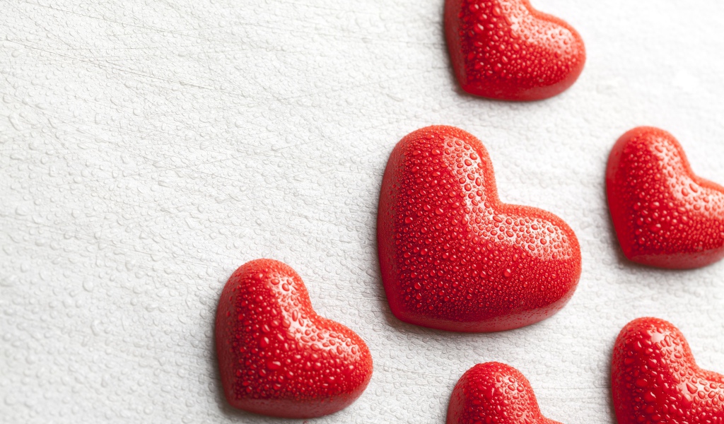 Мокрые красные сердечки на белом фоне