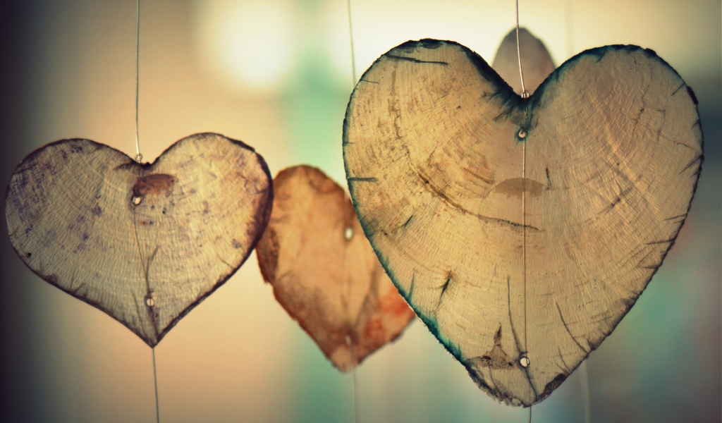 Wooden hearts on a fishing line in the air