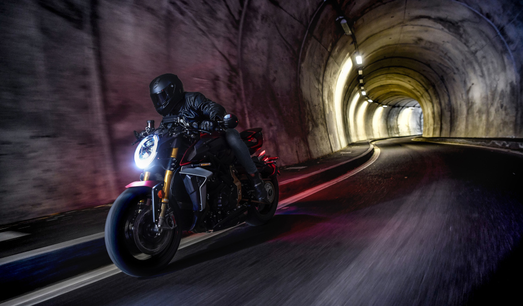Motorcyclist on a motorcycle MV Agusta Brutale 1000 Serie Oro 2019 in the tunnel