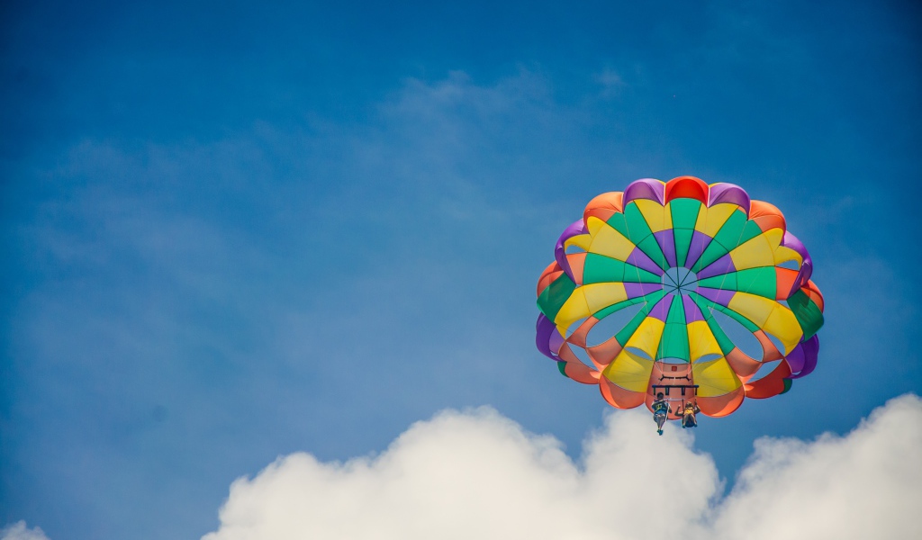 Parachute in the blue sky with white clouds